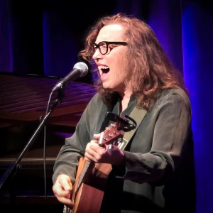 Teresa Trull singing and playing guitar